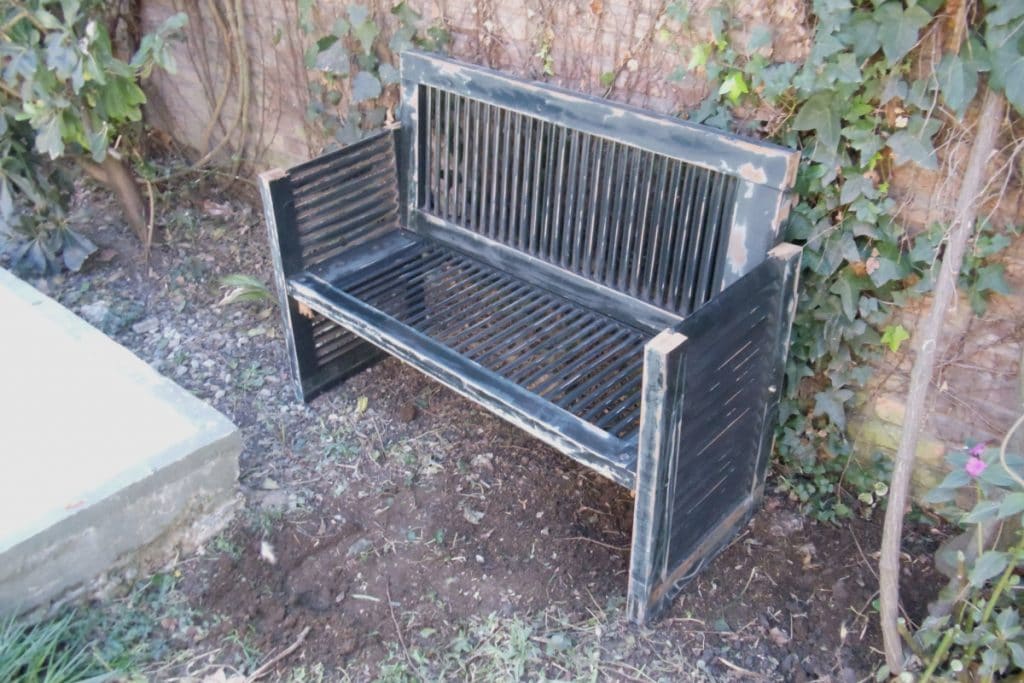 Wooden bench with antique shutter